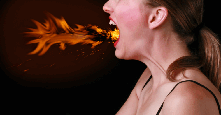 A woman breathing fire from her mouth.