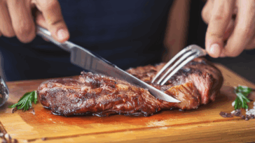 man cutting a steak