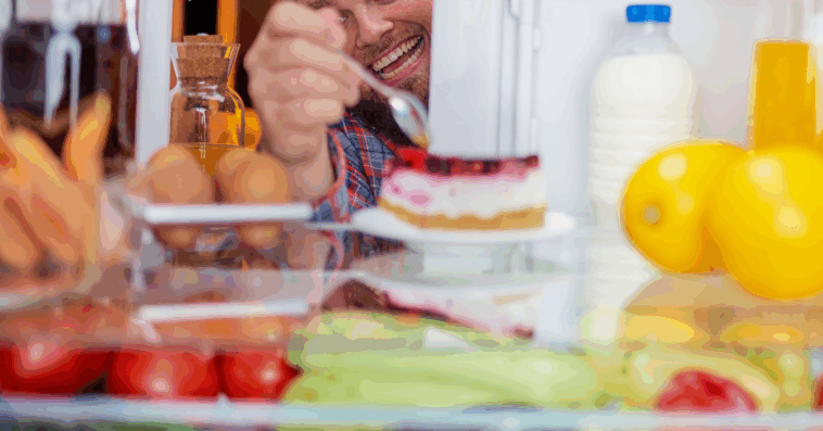 man eating out of refrigerator