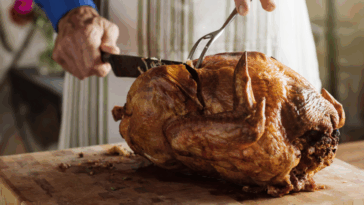 A man carving a turkey.