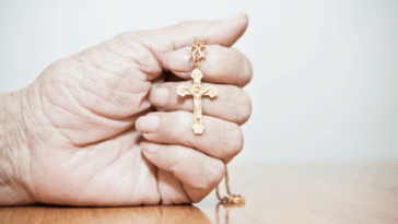 Person holding a cross