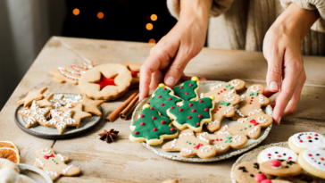 A plate of Christmas cookies on a table.