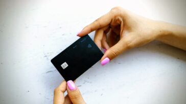 person holding credit card