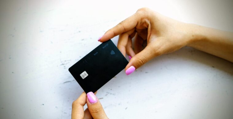 person holding credit card