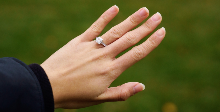 person showing off diamond engagement ring