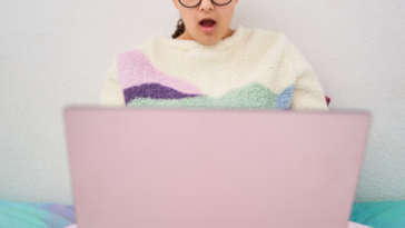 shocked woman looking at laptop screen