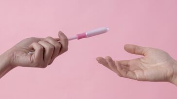 person handing tampon to another person