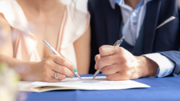 couple signing document together