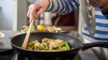 close-up of an older woman cooking
