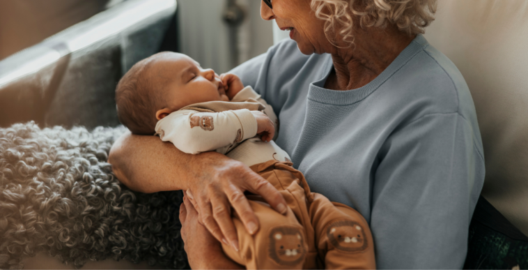 older woman holding infant