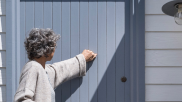 older woman knocking on door