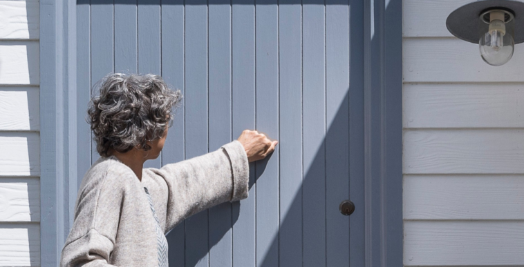 older woman knocking on door