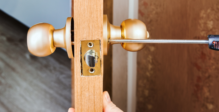 person changing lock on interior door