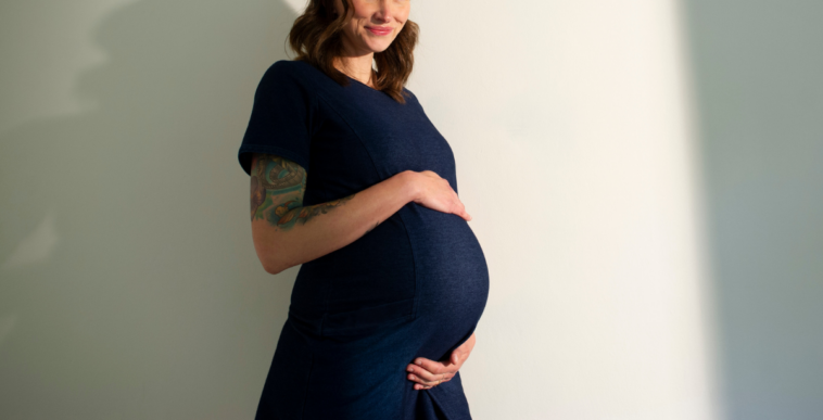 pregnant woman with hands on her belly