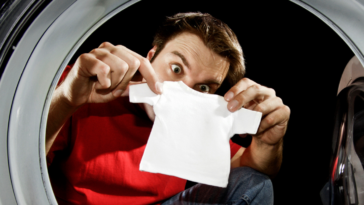 Man looking at shrinking clothes