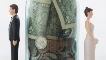 bride and groom figurines with jar of money