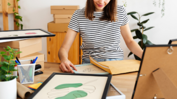 woman framing artwork
