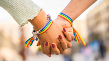two women holding hands