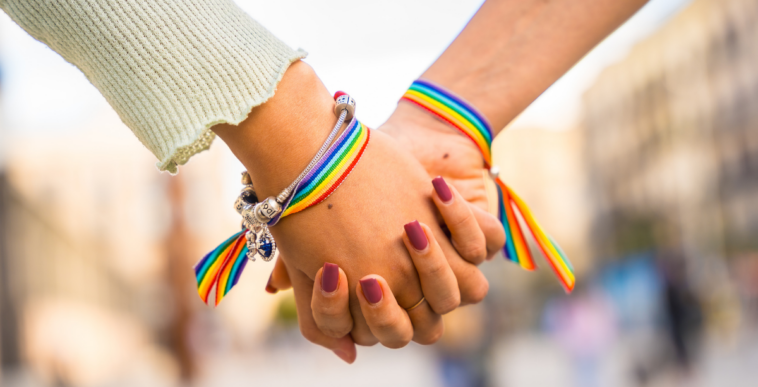 two women holding hands
