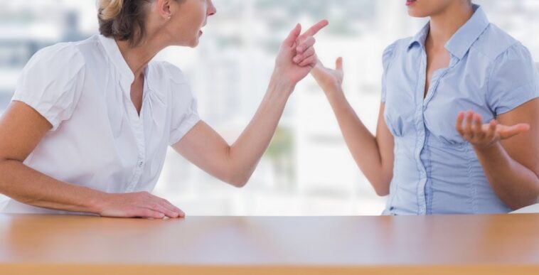 older woman berating younger woman