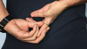 man removing wedding band