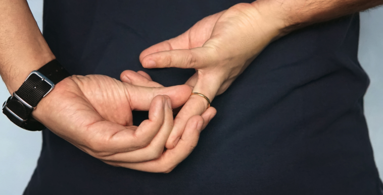 man removing wedding band