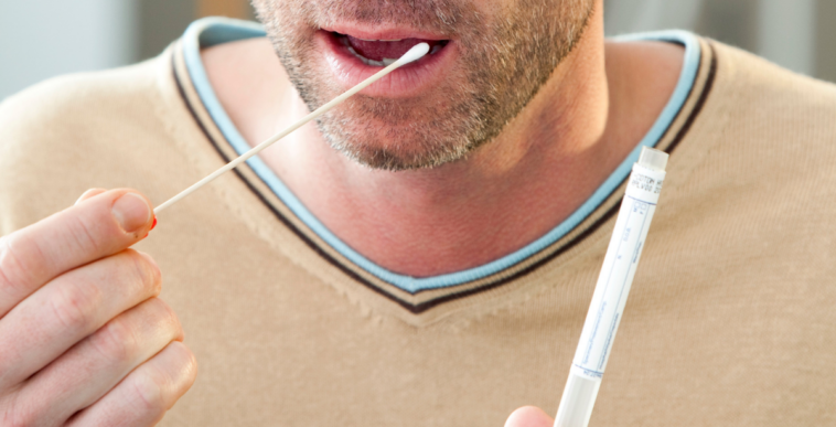 man getting DNA swab for genetic testing