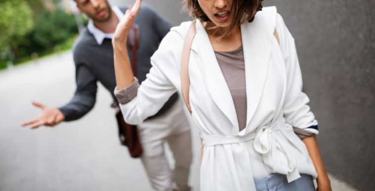 woman walking away from man on street
