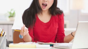 Frustrated young woman working in a home office.