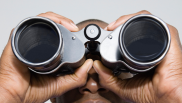 Man looking through binoculars