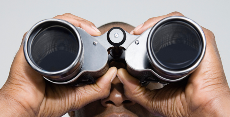Man looking through binoculars