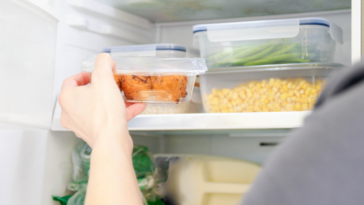 Person taking leftovers out of the fridge