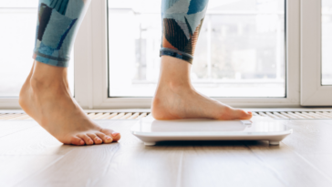 Woman stepping on to a scale