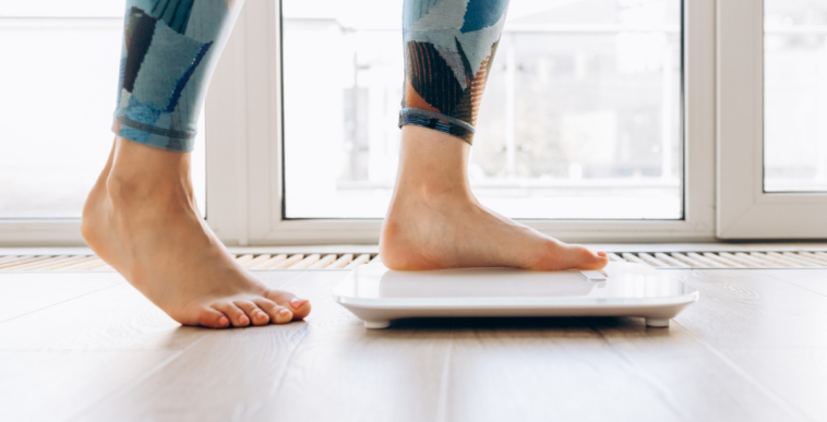 Woman stepping on to a scale