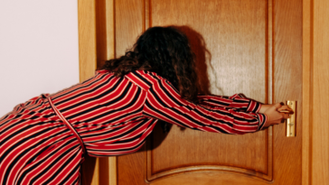 Woman pulling on door handle