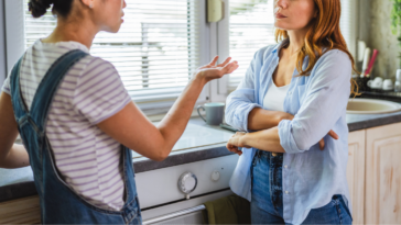 two women have disagreement in kitchen