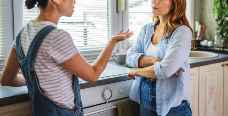 two women have disagreement in kitchen