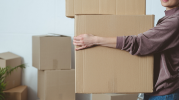 woman carrying moving boxes