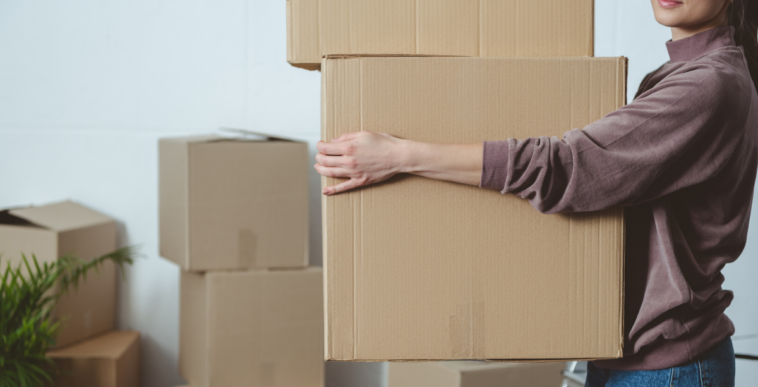 woman carrying moving boxes