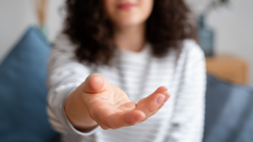 woman holding hand out asking for something