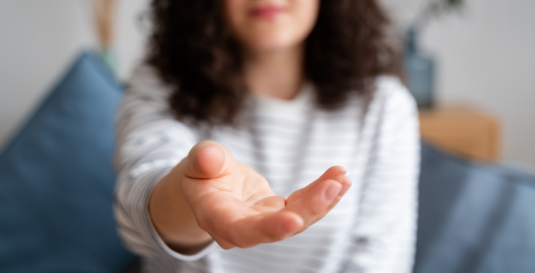 woman holding hand out asking for something